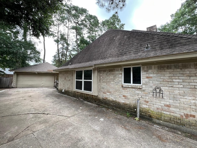 17506 Rustington Dr, Spring, TX 77379 - view of front of house with roof with shingles, a chimney, a garage, and concrete driveway