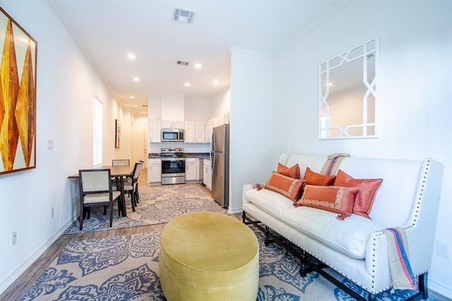 5119 Briscoe St A/B, Unit A/B Houston, TX 77033 - living area featuring light wood-type flooring, recessed lighting, and crown molding