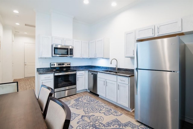 5119 Briscoe St A/B, Unit A/B Houston, TX 77033 - kitchen with stainless steel appliances, light wood-style flooring, recessed lighting, and crown molding