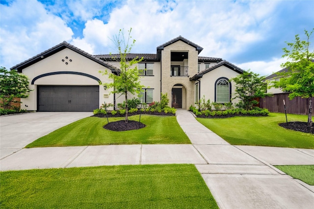 3242 N Upland St, Katy, TX 77493 - mediterranean / spanish house featuring a tiled roof, driveway, stucco siding, and a garage