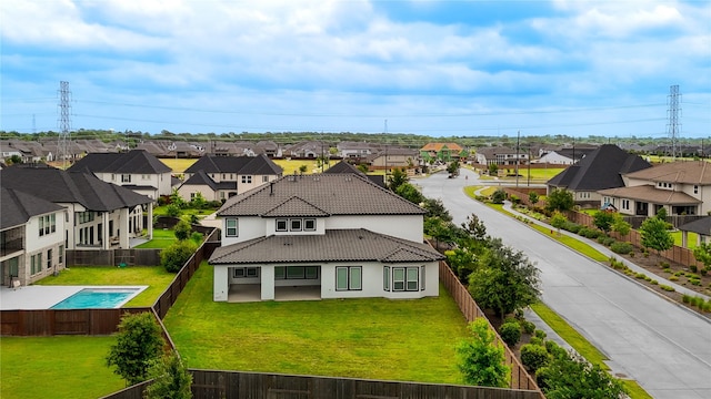 3242 N Upland St, Katy, TX 77493 - rear view of house featuring a residential view, stucco siding, a tiled roof, and a fenced backyard
