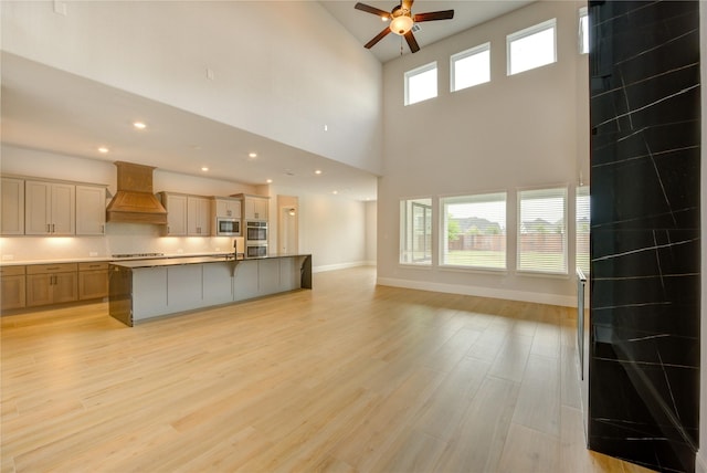3242 N Upland St, Katy, TX 77493 - kitchen featuring custom range hood, appliances with stainless steel finishes, open floor plan, ceiling fan, and a high ceiling