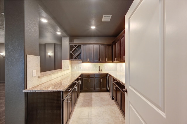 3242 N Upland St, Katy, TX 77493 - kitchen with tasteful backsplash, dark brown cabinetry, light stone counters, recessed lighting, and light tile patterned floors