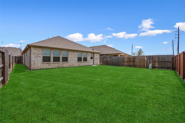 24107 Avocet Creek Rd, Katy, TX 77493 - back of property with a fenced backyard, brick siding, and roof with shingles