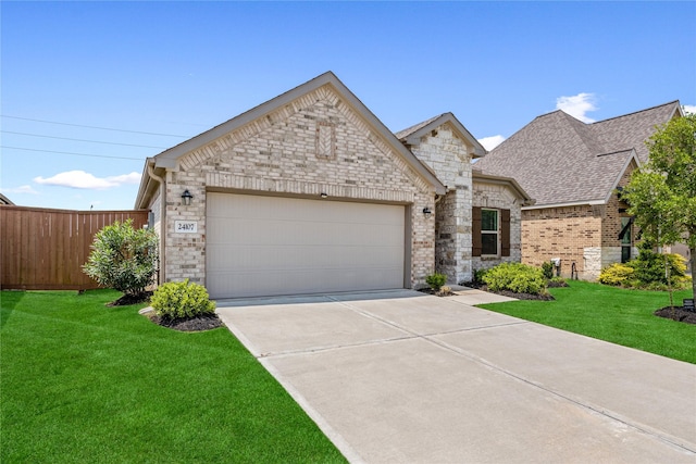 24107 Avocet Creek Rd, Katy, TX 77493 - view of front facade featuring an attached garage, concrete driveway, stone siding, roof with shingles, and brick siding