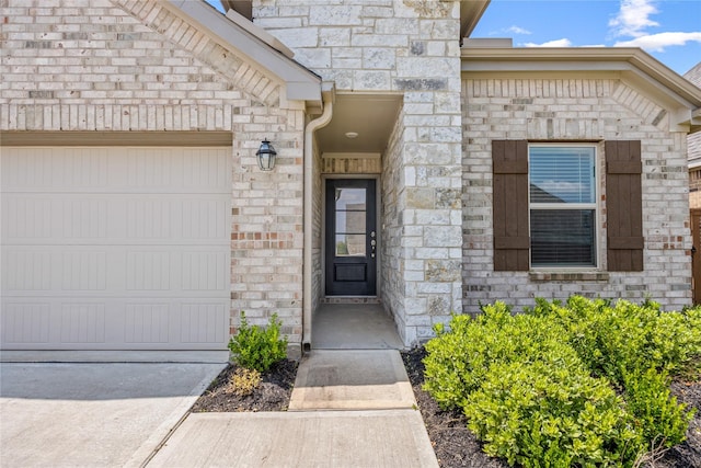 24107 Avocet Creek Rd, Katy, TX 77493 - property entrance with an attached garage, stone siding, and concrete driveway
