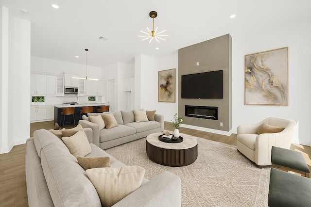 2122 Oatfield Dr, Houston, TX 77018 - living area with wood finished floors, recessed lighting, and a large fireplace
