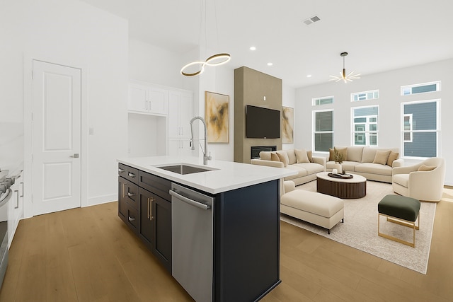 2122 Oatfield Dr, Houston, TX 77018 - kitchen with stainless steel dishwasher, light wood-style floors, open floor plan, light countertops, and recessed lighting