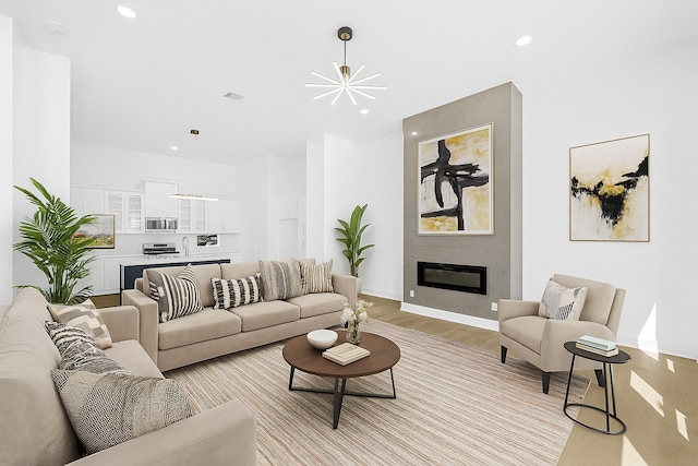 2122 Oatfield Dr, Houston, TX 77018 - living area with recessed lighting, light wood finished floors, a fireplace, and a chandelier