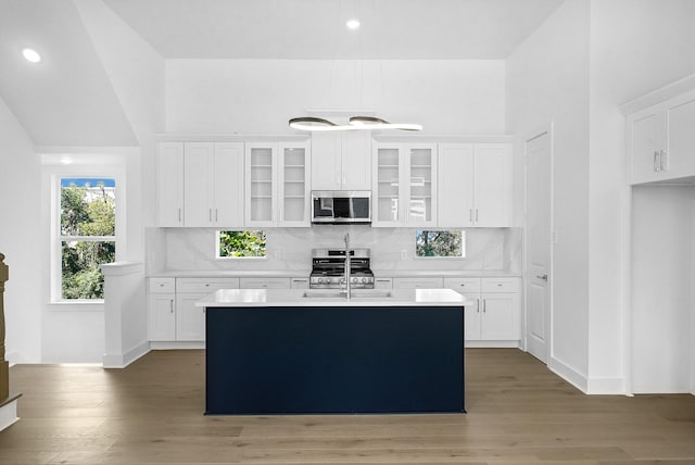 2122 Oatfield Dr, Houston, TX 77018 - kitchen with appliances with stainless steel finishes, white cabinets, light countertops, light wood-type flooring, and recessed lighting
