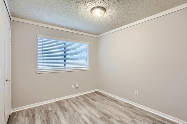 11910 Yearling Dr, Houston, TX 77065 - spare room with wood finished floors, crown molding, and a textured ceiling