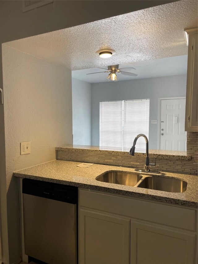 8703 Victorian Village Dr Unit 8703, Houston, TX 77071 - kitchen with dishwasher, a textured ceiling, ceiling fan, backsplash, and light stone counters