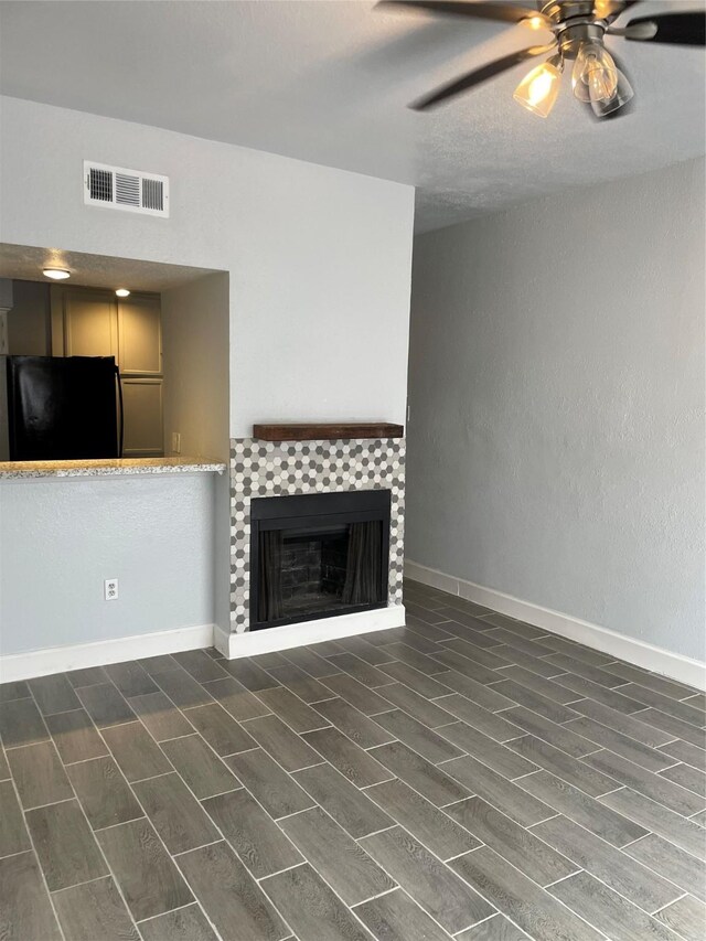 8703 Victorian Village Dr Unit 8703, Houston, TX 77071 - unfurnished living room with ceiling fan, a tile fireplace, and wood tiled floors