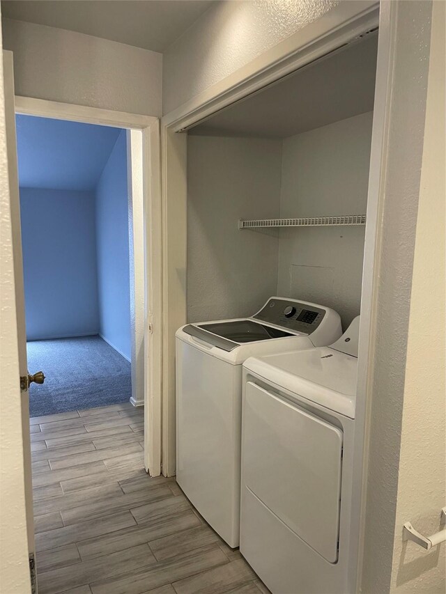 8703 Victorian Village Dr Unit 8703, Houston, TX 77071 - laundry area with washing machine and dryer and light wood-type flooring
