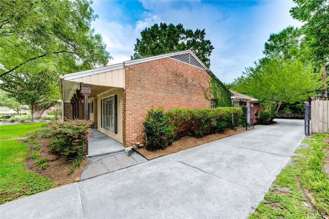 2602 Briarbrook Dr, Houston, TX 77042 - view of side of property featuring brick siding and driveway