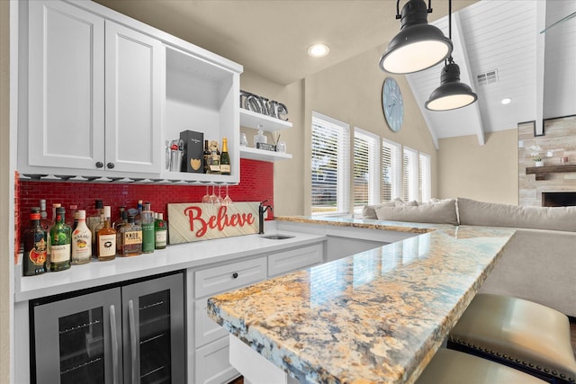 8307 Amber Cove Dr, Atascocita, TX 77346 - indoor dry bar featuring wine cooler, recessed lighting, and hanging light fixtures