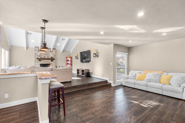 8307 Amber Cove Dr, Atascocita, TX 77346 - living area with healthy amount of natural light, a stone fireplace, dark wood-type flooring, and recessed lighting