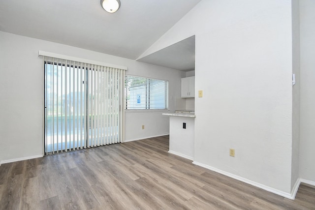 6915 Jeb Stuart Dr, Richmond, TX 77469 - unfurnished living room with vaulted ceiling and wood finished floors