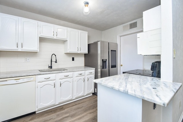 6915 Jeb Stuart Dr, Richmond, TX 77469 - kitchen with dishwasher, white cabinetry, and wood finished floors