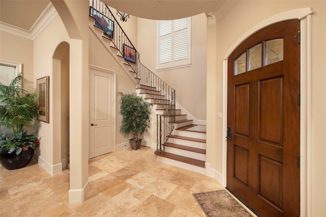 25 N Creekside Ct, Houston, TX 77055 - foyer entrance featuring crown molding, arched walkways, stairs, and a towering ceiling