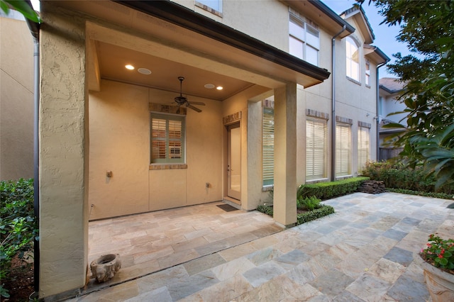 25 N Creekside Ct, Houston, TX 77055 - view of exterior entry with a ceiling fan, a patio, and stucco siding