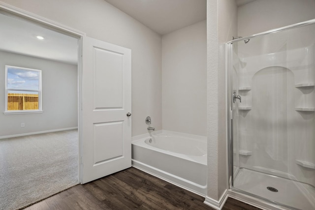10419 Red Cardinal Dr, Houston, TX 77328 - bathroom featuring a shower stall, a garden tub, wood finished floors, and baseboards