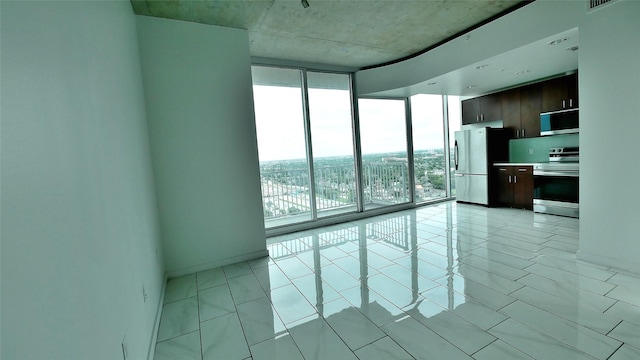 5925 Almeda Rd Unit 12113, Houston, TX 77004 - spare room featuring a wall of windows and baseboards