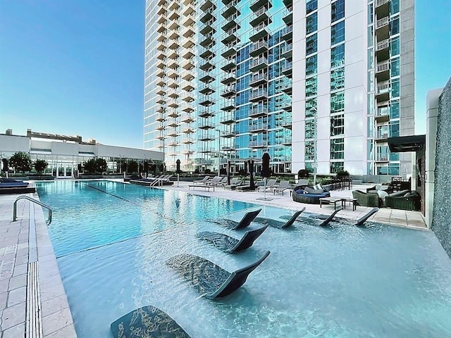 5925 Almeda Rd Unit 12113, Houston, TX 77004 - community pool with a patio area and outdoor lounge area