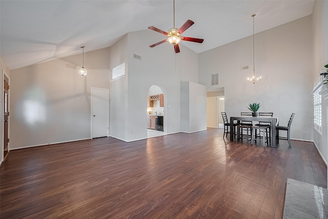 5814 N Magazine Cir, Houston, TX 77084 - unfurnished living room with a ceiling fan, a chandelier, arched walkways, dark wood-type flooring, and high vaulted ceiling