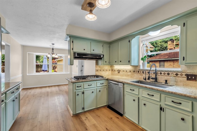 17427 Pinewood Forest Dr, Spring, TX 77379 - kitchen with green cabinetry, stainless steel appliances, and range hood
