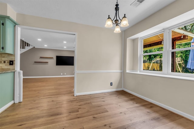 17427 Pinewood Forest Dr, Spring, TX 77379 - unfurnished dining area with a chandelier, light wood finished floors, and recessed lighting