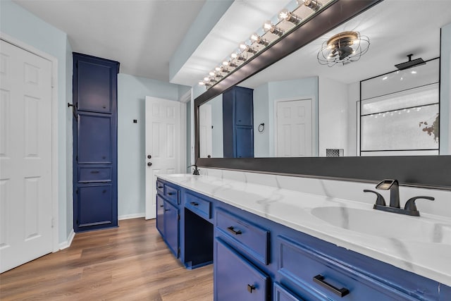 17427 Pinewood Forest Dr, Spring, TX 77379 - bathroom featuring double vanity and wood finished floors