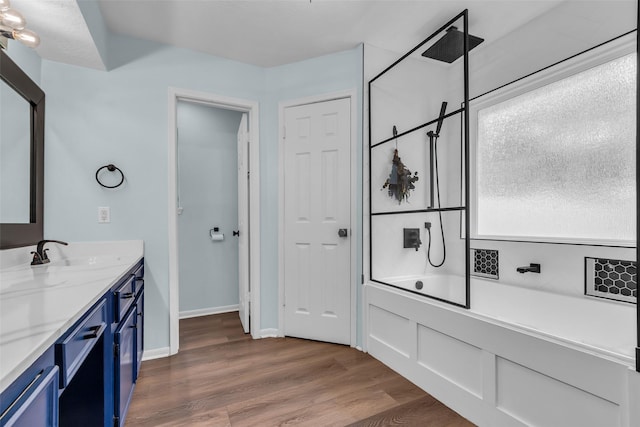 17427 Pinewood Forest Dr, Spring, TX 77379 - bathroom with vanity, a combined bath / shower with rainfall shower, and wood finished floors