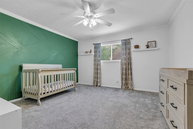 17427 Pinewood Forest Dr, Spring, TX 77379 - carpeted bedroom with crown molding, a crib, and a ceiling fan