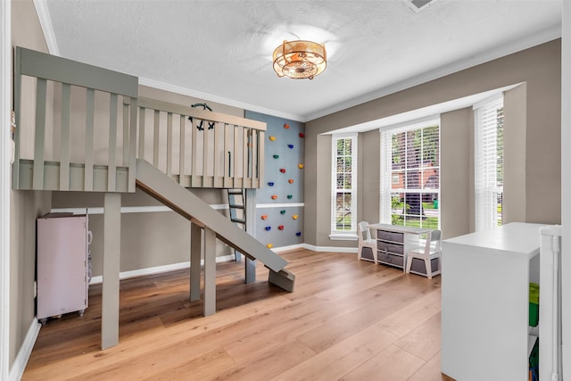 17427 Pinewood Forest Dr, Spring, TX 77379 - bedroom featuring wood finished floors, ornamental molding, and a textured ceiling