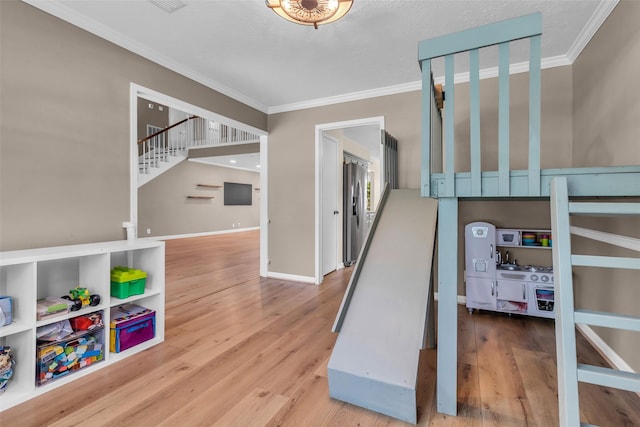 17427 Pinewood Forest Dr, Spring, TX 77379 - stairs featuring crown molding and wood finished floors
