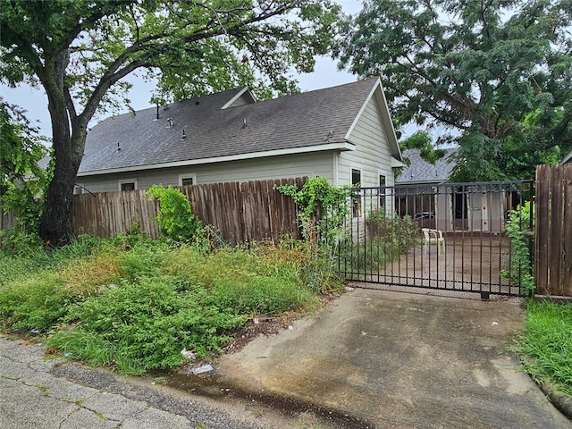 3022 Mcilhenny St, Houston, TX 77004 - view of property exterior featuring roof with shingles and a gate