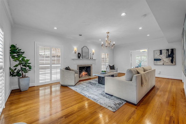 2539 Addison Rd, Houston, TX 77030 - living area featuring recessed lighting, light wood finished floors, crown molding, a chandelier, and a fireplace
