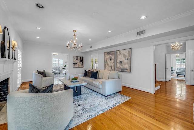2539 Addison Rd, Houston, TX 77030 - living room featuring a chandelier, ornamental molding, light wood-style flooring, plenty of natural light, and recessed lighting