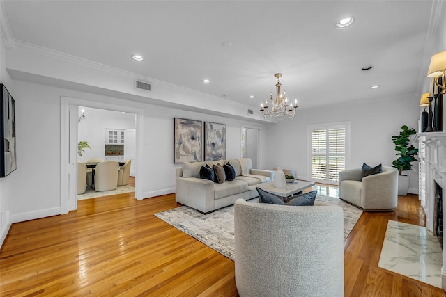 2539 Addison Rd, Houston, TX 77030 - living room featuring crown molding, light wood-type flooring, recessed lighting, a chandelier, and a high end fireplace