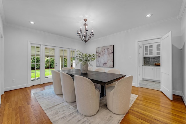 2539 Addison Rd, Houston, TX 77030 - dining space with french doors, a chandelier, light wood finished floors, recessed lighting, and ornamental molding