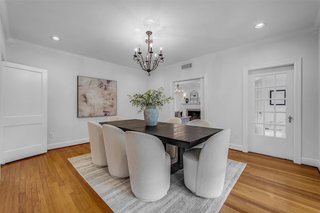 2539 Addison Rd, Houston, TX 77030 - dining room with a chandelier, light wood finished floors, crown molding, and recessed lighting