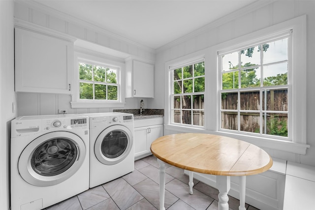 2539 Addison Rd, Houston, TX 77030 - laundry area with cabinet space, washer and dryer, healthy amount of natural light, ornamental molding, and light tile patterned floors
