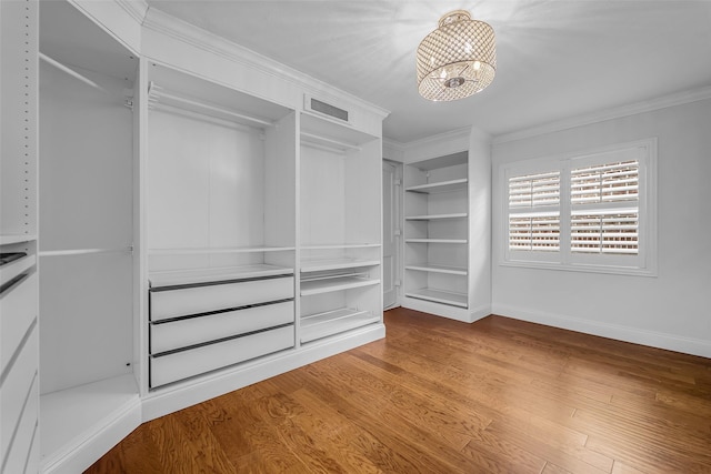 2539 Addison Rd, Houston, TX 77030 - spacious closet featuring a chandelier and wood finished floors