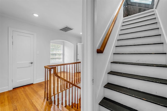2539 Addison Rd, Houston, TX 77030 - stairway with arched walkways, wood finished floors, ornamental molding, and recessed lighting