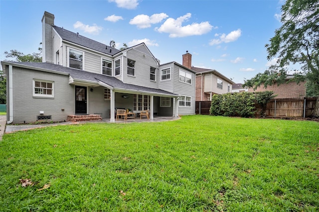 2539 Addison Rd, Houston, TX 77030 - rear view of property with a fenced backyard, a chimney, and a patio