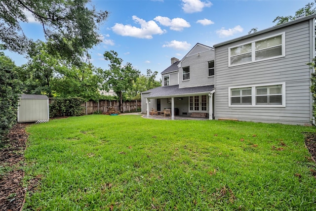 2539 Addison Rd, Houston, TX 77030 - rear view of property with a patio area, a storage shed, a fenced backyard, and a chimney