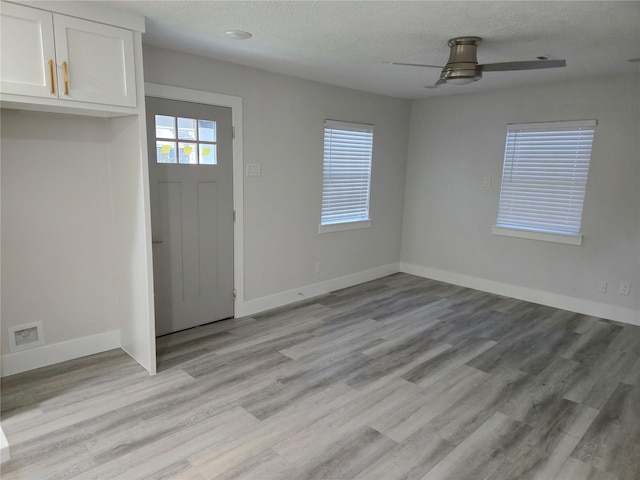 4104 Idaho St, Houston, TX 77021 - entryway featuring ceiling fan, light wood-style flooring, and a textured ceiling