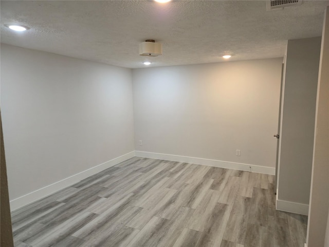 4104 Idaho St, Houston, TX 77021 - spare room with light wood-style flooring, a textured ceiling, and recessed lighting