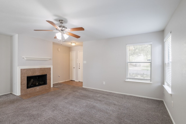 12026 Madison Oak St, Houston, TX 77038 - unfurnished living room with healthy amount of natural light, a ceiling fan, a tile fireplace, and carpet